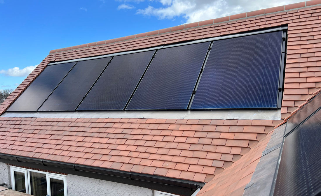 Photo of solar PV panels set into the roof of an existing property